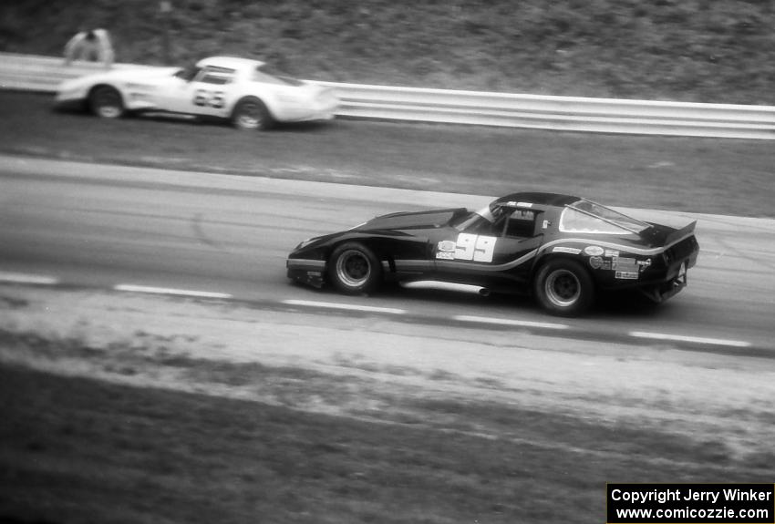 Phil Currin's Chevy Corvette laps the stopped Chevy Corvette of Larry Gross.