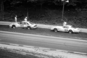 Tom Gloy's Ford Mustang and Larry Gross's Chevy Corvette stopped just beyond turn 12