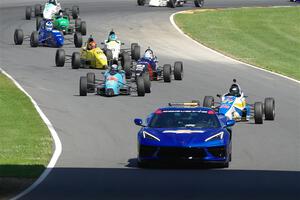 The pace car brings the field through the carousel.