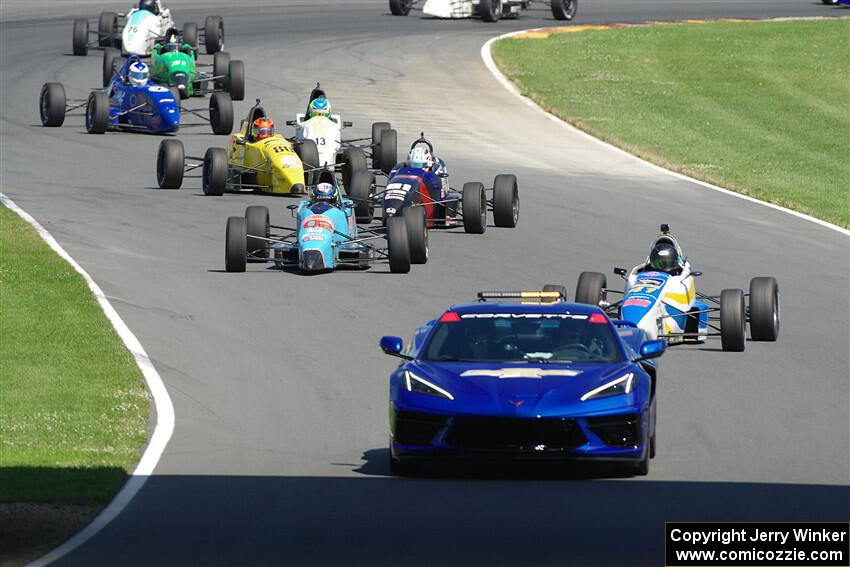 The pace car brings the field through the carousel.