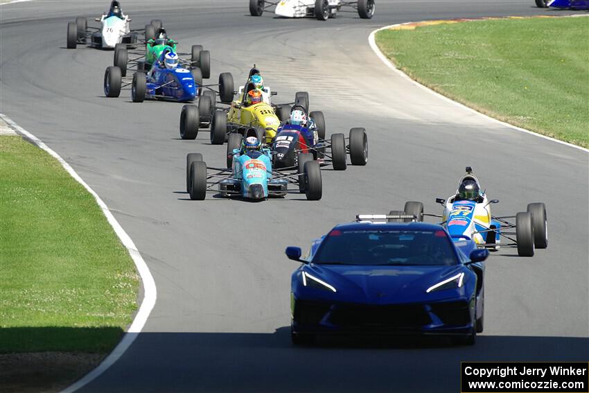 The pace car brings the field through the carousel.