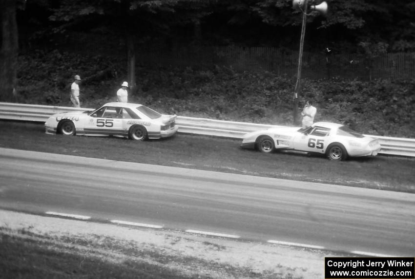 Tom Gloy's Ford Mustang and Larry Gross's Chevy Corvette stopped just beyond turn 12