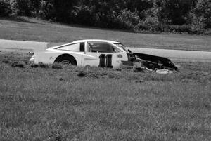 Art Siri, Jr.'s Chevy Monza and Ralph Kent-Cooke's Chevy Camaro against the berm after turn 5