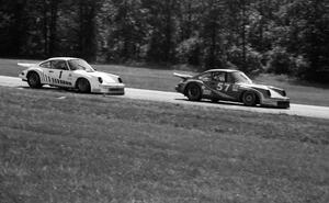 Monte Shelton's Porsche 930 ahead of John Bauer's Porsche 911SC entering turn 6