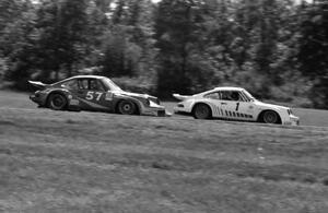 John Bauer's Porsche 911SC ahead of Monte Shelton's Porsche 930 through turn 6