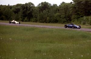 Paul Petit's Lola T-540 leads Gene Anderson's Crossle 35F into turn 3 during Formula Ford practice.