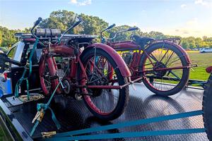1911 Indian motorcycle on the left, and a 1912 Indian motorcycle on the right.