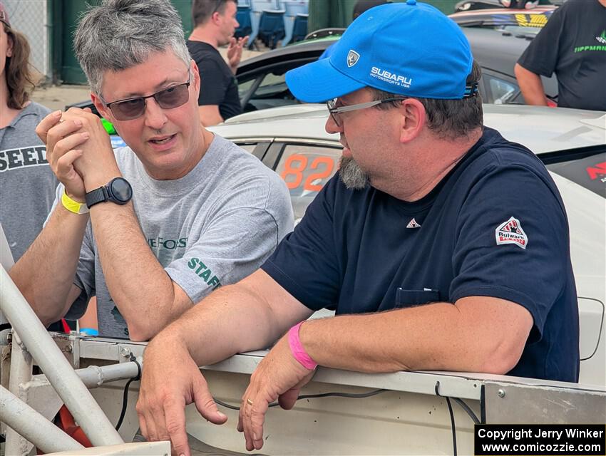 Jim Cox and Scott Parrott converse at parc expose at Soo Pass Ranch.