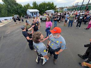 Richard Donovan and Greg Donovan converse at parc expose at Soo Pass Ranch.