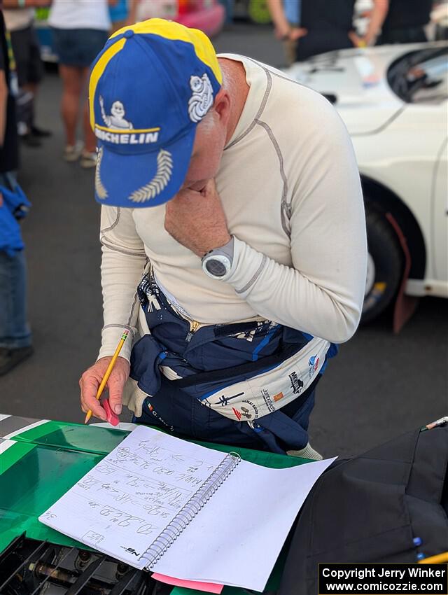 Gary McElhinney goes over his pace notes at parc expose at Soo Pass Ranch.