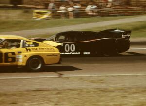 Ted Field's Lola T-600/Chevy passes Jack Buchinger's Datsun 280ZX down the front straight.