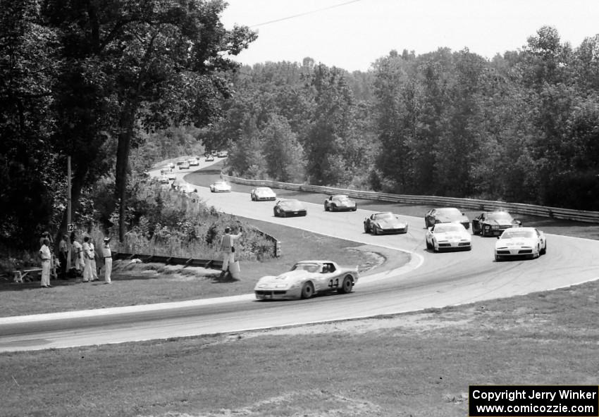 Jerry Hansen's Chevy Corvette leads the field through turn 12 on the pace lap.