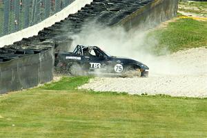 Parker Kligerman's Mazda MX-5 Cup backs it into the tires at turn 6.