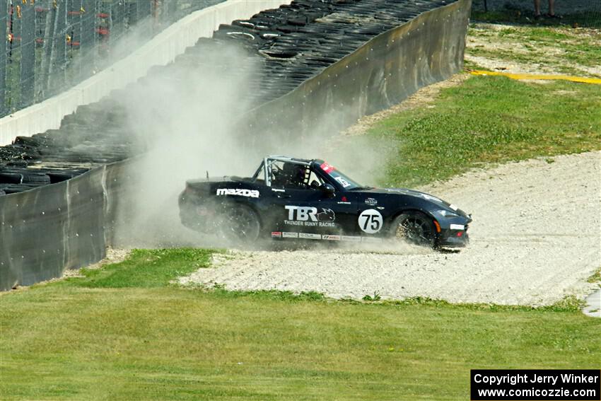 Parker Kligerman's Mazda MX-5 Cup backs it into the tires at turn 6.