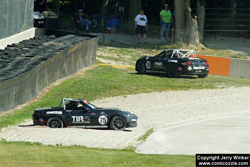 Parker Kligerman's Mazda MX-5 Cup gets stuck in the gravel. John Jodoin pulls off course.