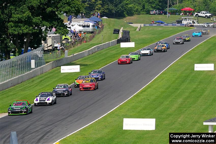 The field streams down the Hurry Downs into turn 8, on lap 1 of race 2.