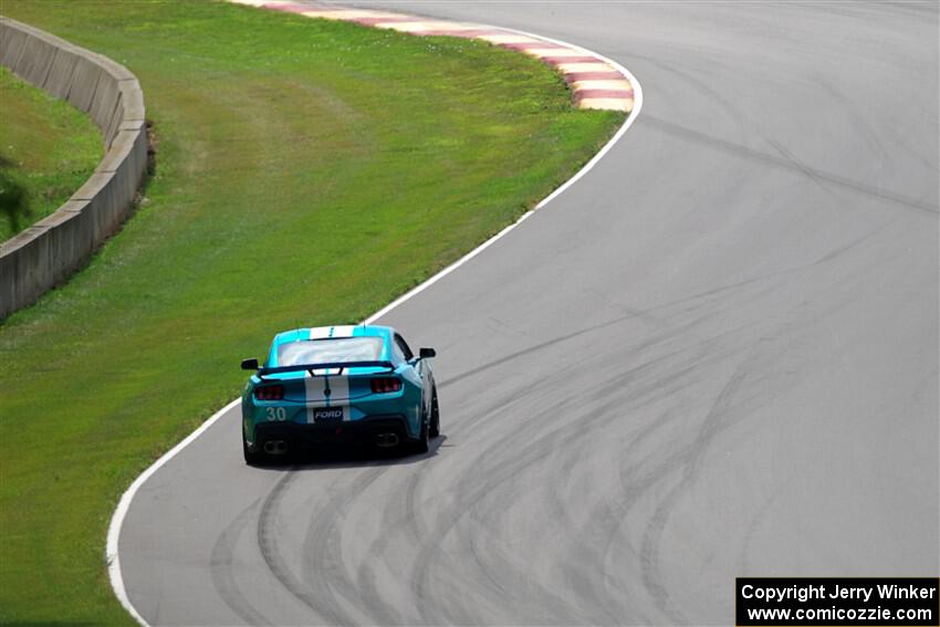 Scott Thomson's Ford Mustang Dark Horse R limps through Thunder Valley on the pace lap of race 2.