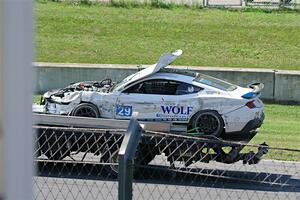 Mitch Marvosh's Ford Mustang Dark Horse R comes by on the flatbed.