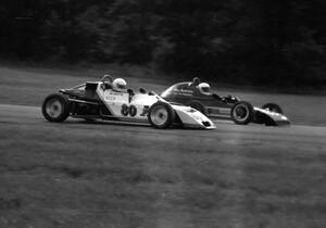 Herb Miller's Crossle 35F gets the inside line on Kurtis Goertz's Dulon MP19 during the Formula Ford race.