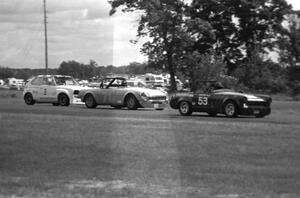 Lona Bradbury's G Prod. Austin-Healey Sprite leads Gene Kunde's E Production MGB and Tom Depagter's GT-4 Honda Civic