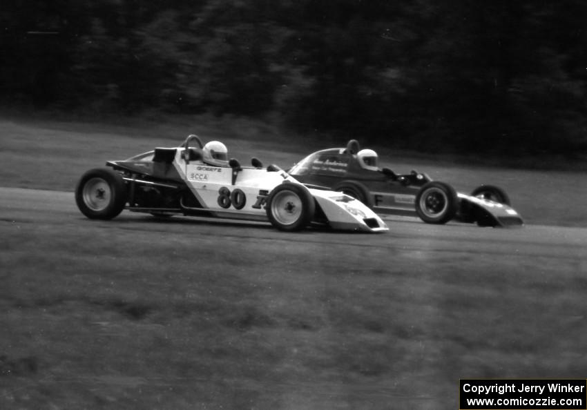 Herb Miller's Crossle 35F gets the inside line on Kurtis Goertz's Dulon MP19 during the Formula Ford race.