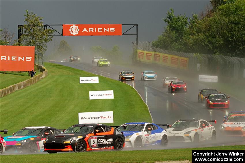 The field streams down into turn 3 on the restart.