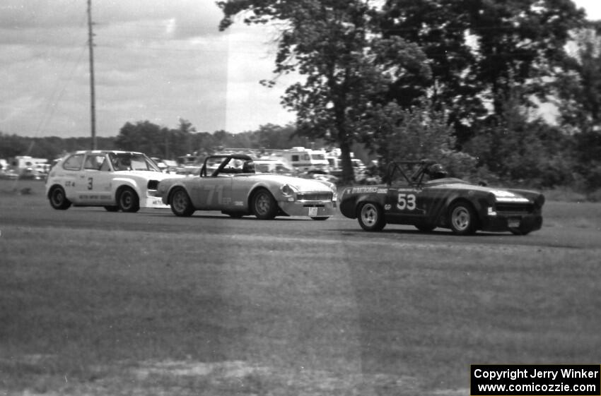 Lona Bradbury's G Prod. Austin-Healey Sprite leads Gene Kunde's E Production MGB and Tom Depagter's GT-4 Honda Civic