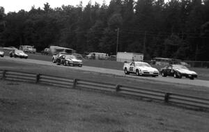 The gridded field comes down the Kinnard Straight on the pace lap.