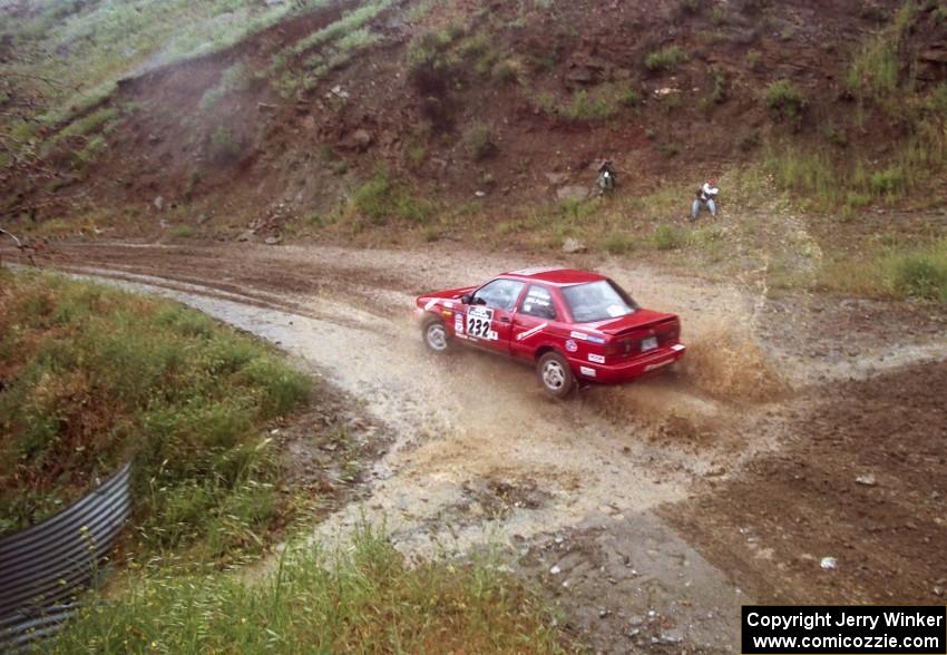 The Mark Tabor / Kevin Poirier Nissan Sentra SE-R hits a stream on Del Sur 1.