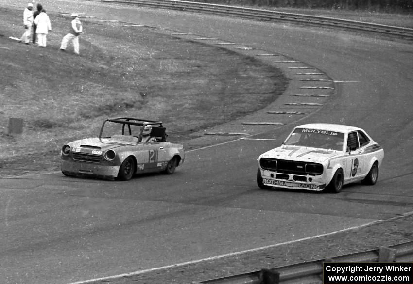 Don Haaversen's D Production Datsun 2000 gets the inside line on Jim King's GT-3 Datsun 710 under the bridge.