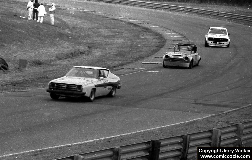 Frank Vogel's GT-3 Datsun 200SX leads Don Haaversen's D Production Datsun 2000 and Jim King's GT-3 Datsun 710 before the bridge.