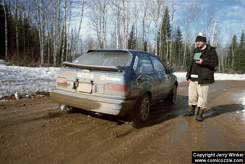 Andy Mohrlant / Chris Huntington Mazda 323GTX leaves the start of SS10, Camp 30.