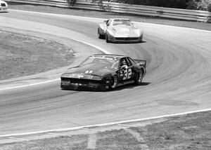 Mark Pielsticker's Chevy Camaro chased by Jim Sanborn's Chevy Corvette