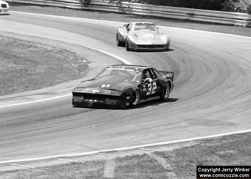 Mark Pielsticker's Chevy Camaro chased by Jim Sanborn's Chevy Corvette