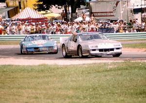 Paul DePirro's Chevy Camaro is chased by Dave Watson's Pontiac Firebird