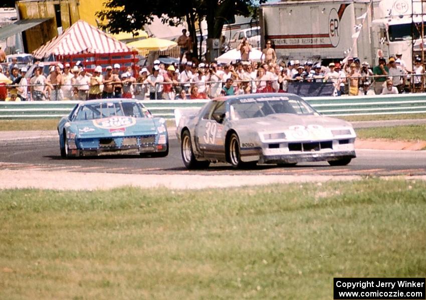 Paul DePirro's Chevy Camaro is chased by Dave Watson's Pontiac Firebird