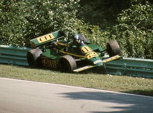 Chris Kneifel's Primus LR03/Cosworth collects the inside guardrail at turn 12 on lap 2.