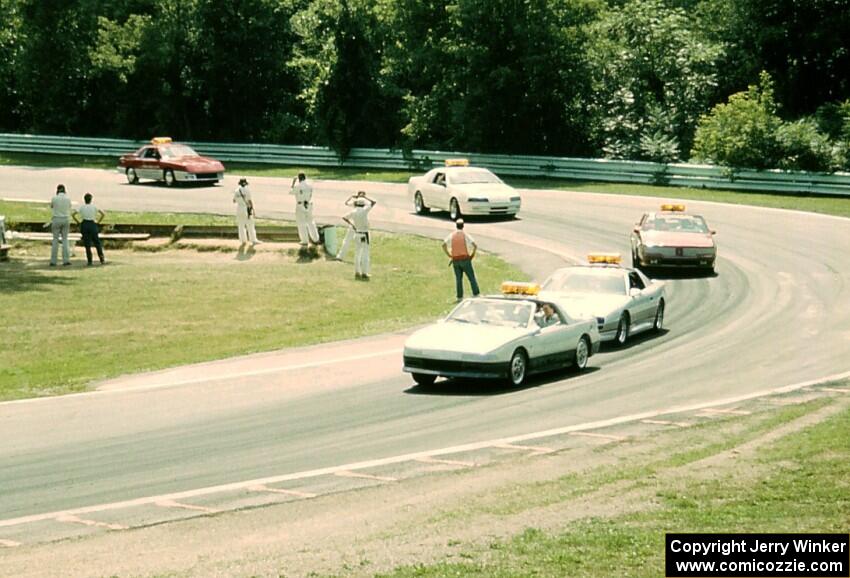 The PPG pace cars come through turn 12.