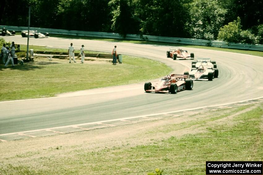 The field comes through Canada Corner (turn 12) on lap one.