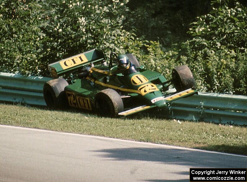 Chris Kneifel's Primus LR03/Cosworth collects the inside guardrail at turn 12 on lap 2.