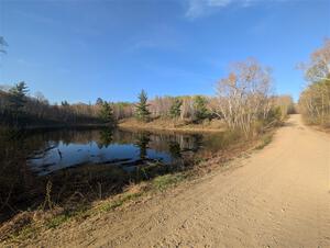 The view of a small lake at the NE corner of the crossroads.