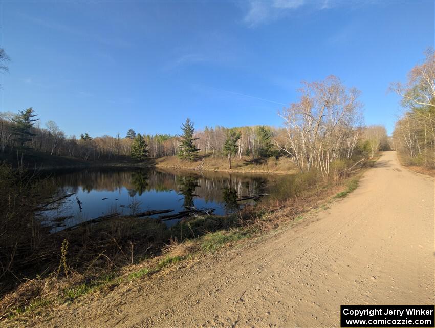 The view of a small lake at the NE corner of the crossroads.
