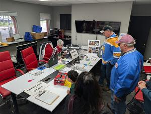 Crews and workers head through registration at the track's front entrance.