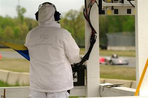 Justin Elder's and Ben Anderson's Spec Racer Ford 3s come into turn 4 as a corner worker watches.
