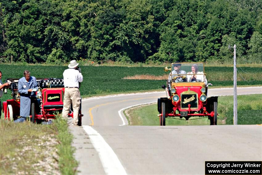 Gregory Gumtow's 1904 Overland is stopped on a hill as Jerry Johnson's 1908 Maxwell passes by.