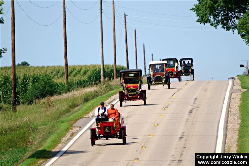 Five cars stream down a hill on the way into Buffalo.