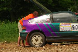 A course marshal repairs a battery issue on the Maegan Burkart / Joanna Seaman Honda CRX Si on SS2, Skunk Creek.