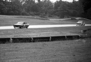 GT-4 battle: Tom Howen's Datsun B210 leads Joe Maloy's Datsun 510