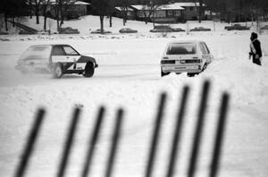 B.J. Greber / Tori Kittredge / Bob Fischer VW Rabbit at pit exit while the Adam Popp / Denny Popp Dodge Colt Turbo passes by.