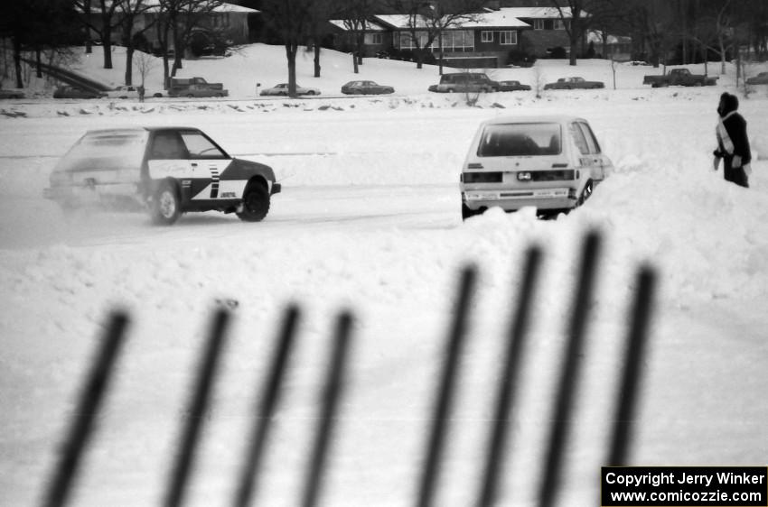 B.J. Greber / Tori Kittredge / Bob Fischer VW Rabbit at pit exit while the Adam Popp / Denny Popp Dodge Colt Turbo passes by.